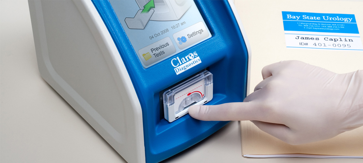 Photograph of hand inserting a cartridge into a PSA testing device