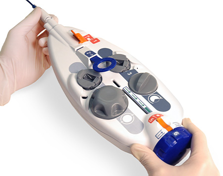 A photograph of some hands showing a medical device.