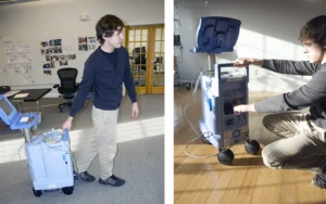 One of our designers pulling a medical cart across a room